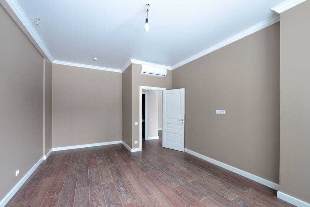 Elite Brushworks painting an empty apartment room in Madison Alabama